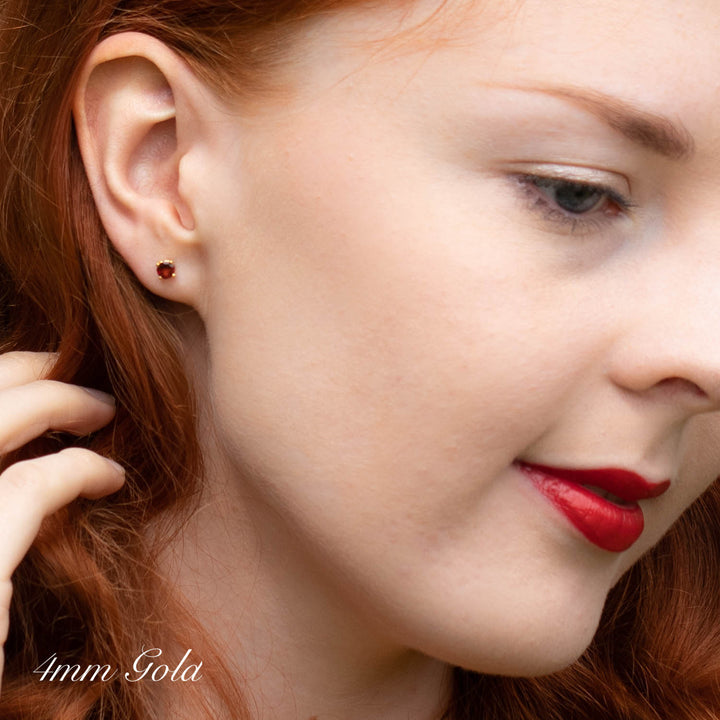 4mm Garnet Stud Earrings on a woman