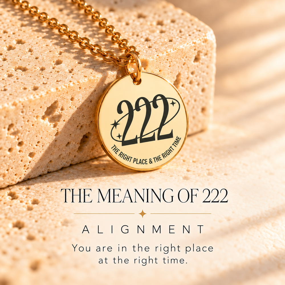 Round gold 222 angel number pendant on sunlit stone, engraved 'the right place and the right time' — 222 means alignment