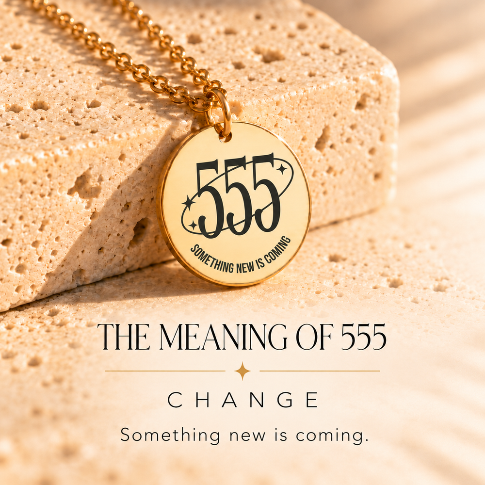 Round gold 555 angel number pendant on sunlit stone, engraved 'something new is coming' — 555 means change