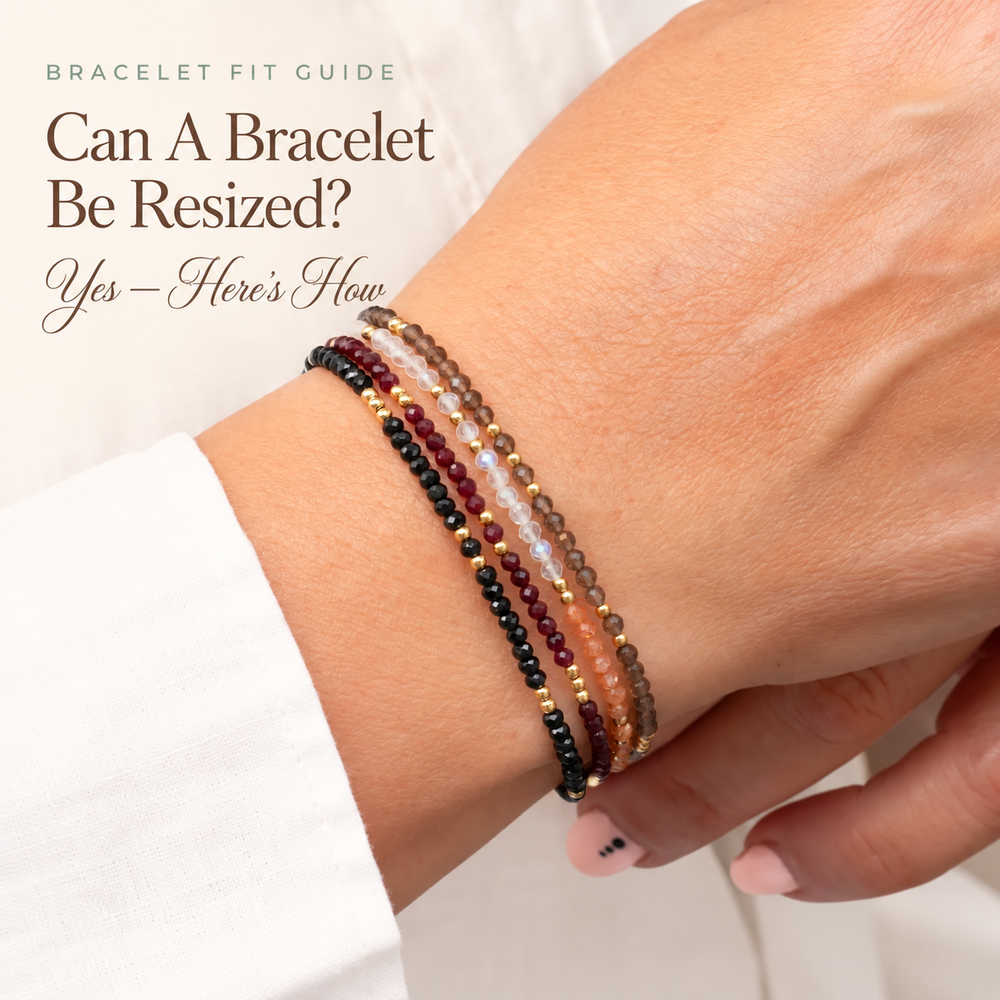 Can a Bracelet Be Resized? — a wrist wearing several fine beaded gemstone bracelets in dark red, black and grey