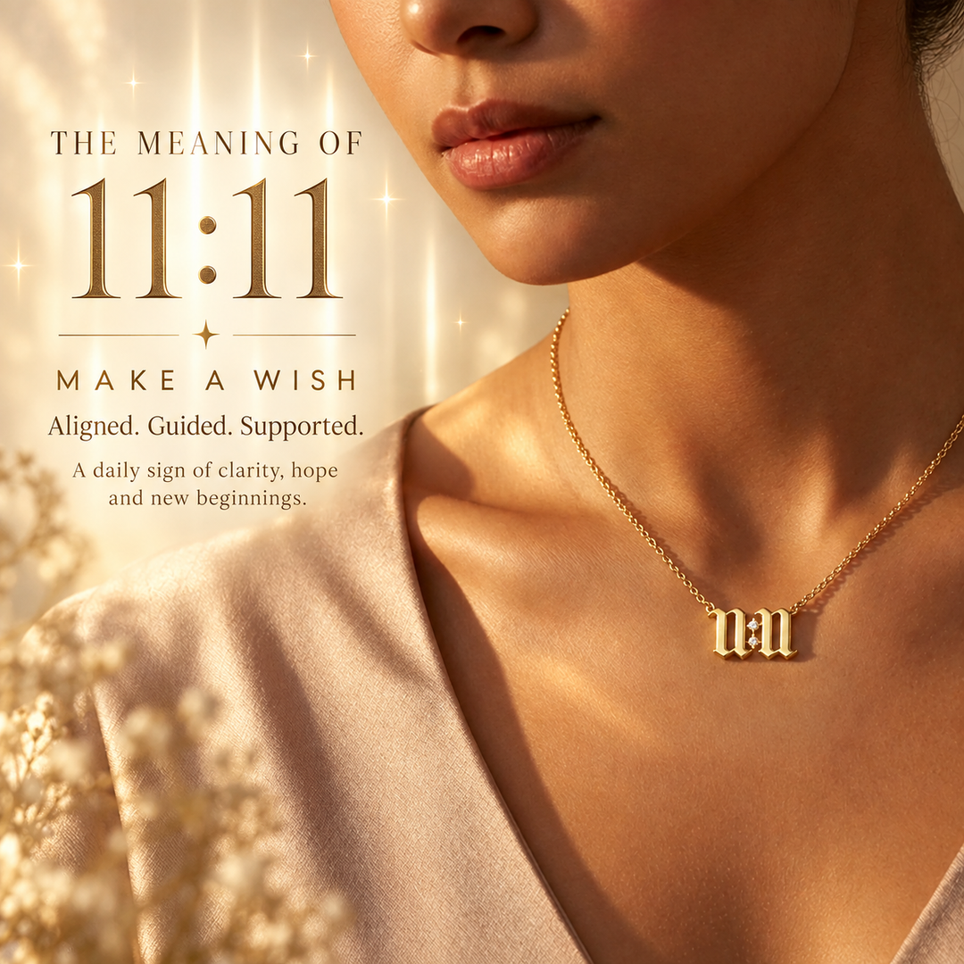 Gold 11:11 necklace in Old English script worn over a blush satin top — 11:11 is a sign to make a wish