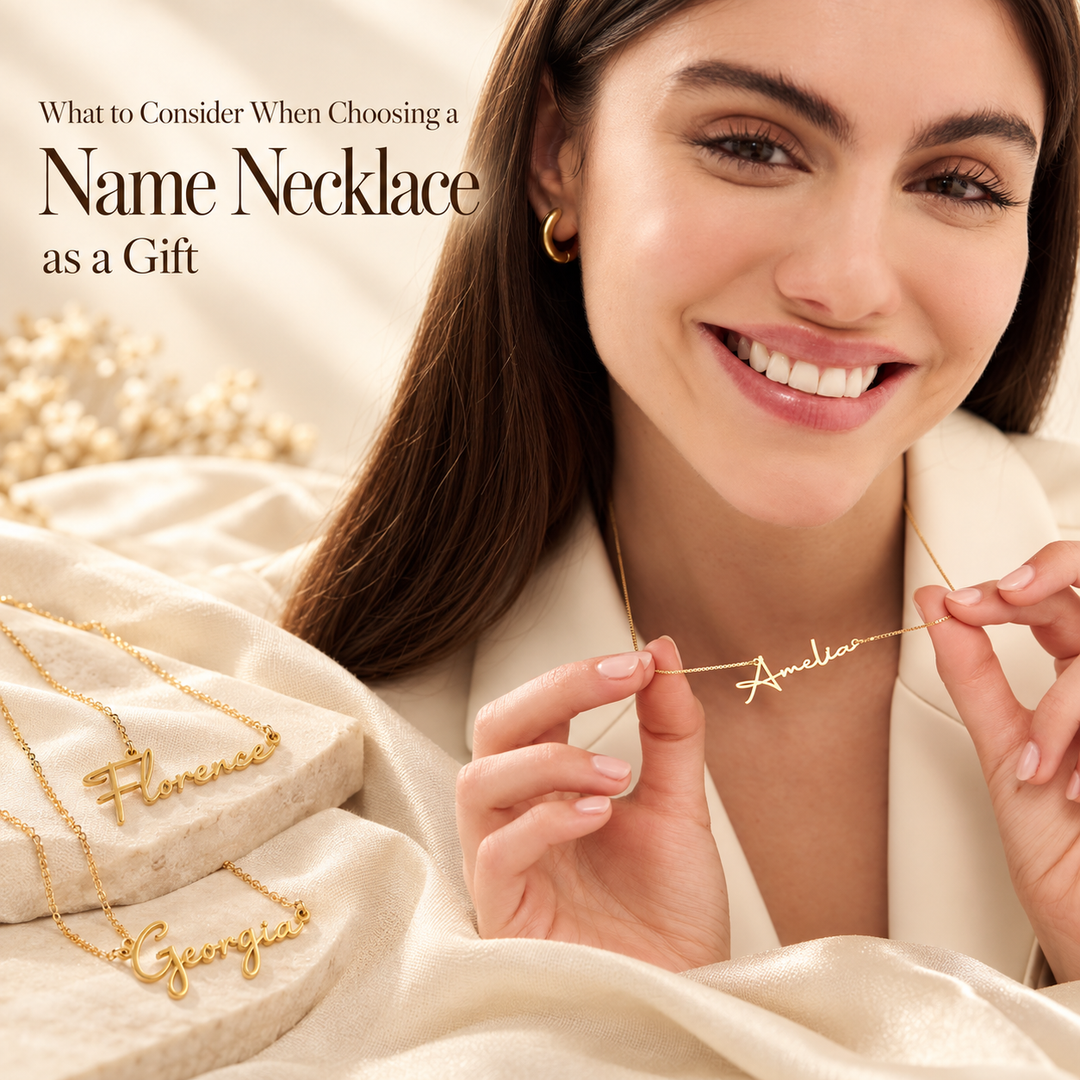 What to Consider When Choosing a Name Necklace as a Gift — a smiling woman holding a gold script Amelia name necklace, with Florence and Georgia name necklaces on cream fabric beside her