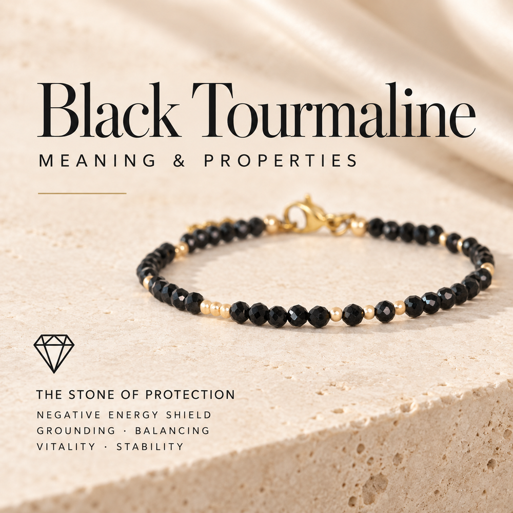 Black Tourmaline Meaning and Properties, the Stone of Protection — a black tourmaline and gold beaded bracelet on travertine, captioned negative energy shield, grounding, balancing, vitality and stability