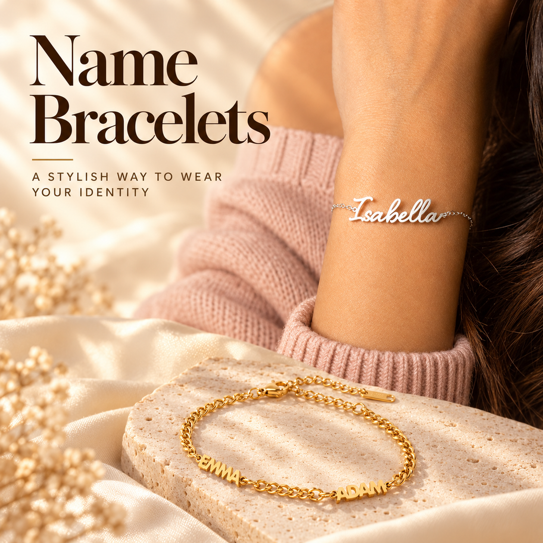 Name Bracelets, a stylish way to wear your identity — a silver script Isabella name bracelet worn on the wrist, above a gold curb-chain bracelet spelling Emma and Adam