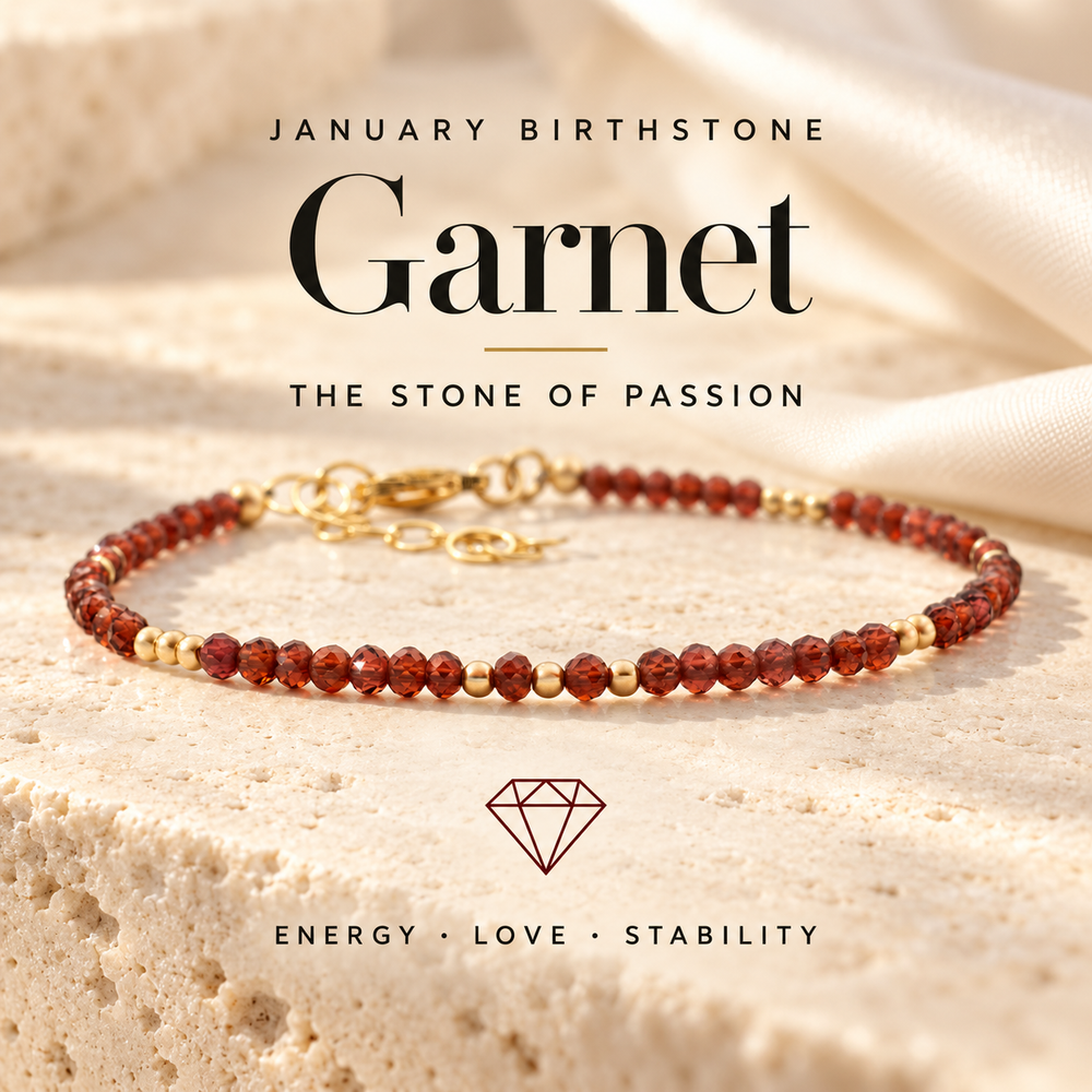 January Birthstone Garnet, the Stone of Passion — a deep red garnet and gold beaded bracelet on travertine, captioned Energy · Love · Stability