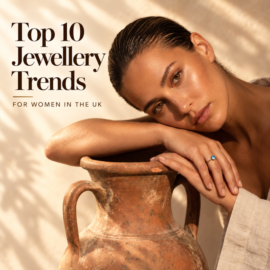 Top 10 Jewellery Trends for Women in the UK — a woman resting against a terracotta urn in sunlight, wearing a gold ring set with a blue topaz stone