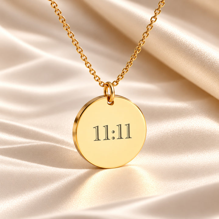 Gold 11:11 necklace with the angel number engraved on a round disc pendant