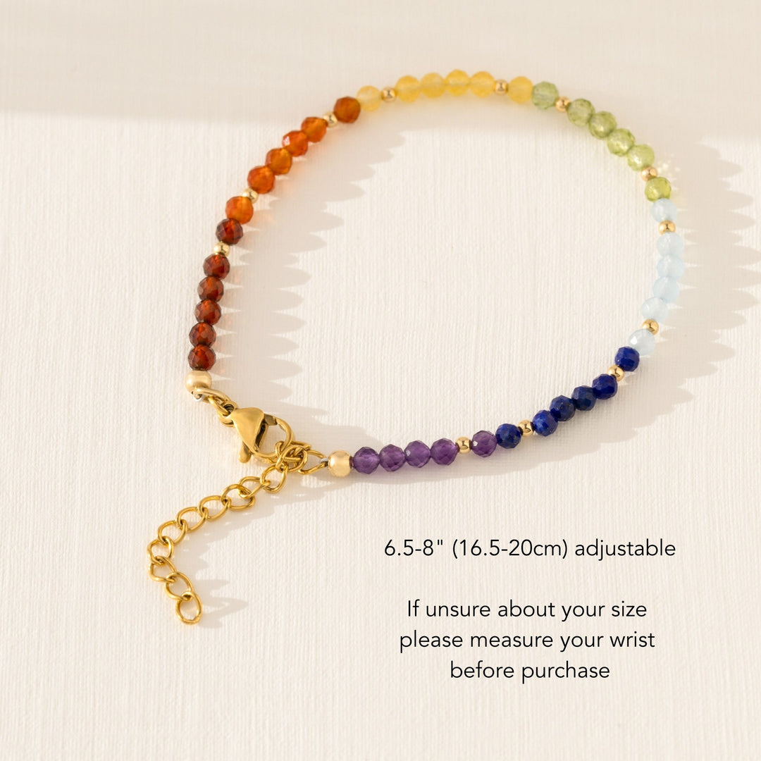Handmade 7 chakra bracelet with natural crystal beads on white background