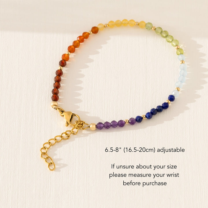 Handmade 7 chakra bracelet with natural crystal beads on white background