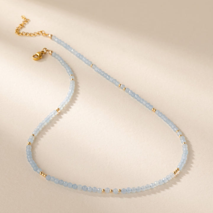 Real aquamarine necklace flat lay — full strand with lobster clasp and 2" extender detail 