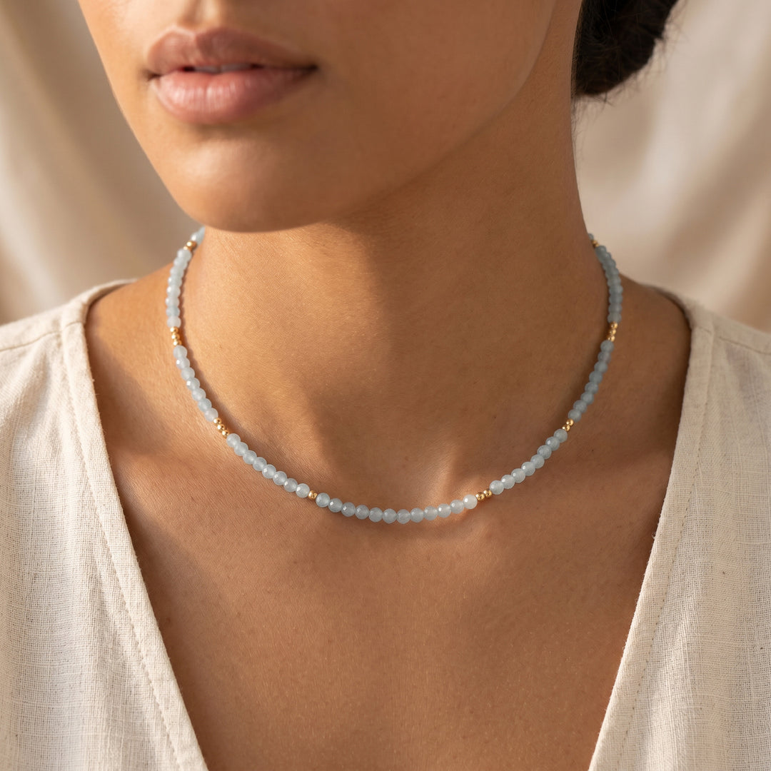 Real aquamarine necklace on model — sea-blue 3mm diamond-cut detail, hand-strung close-up