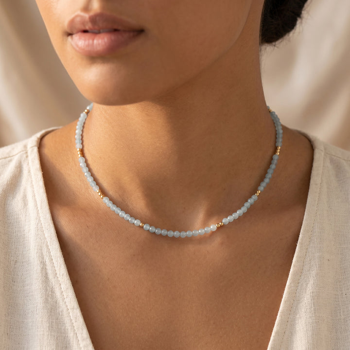 Real aquamarine necklace on model — sea-blue 3mm diamond-cut detail, hand-strung close-up