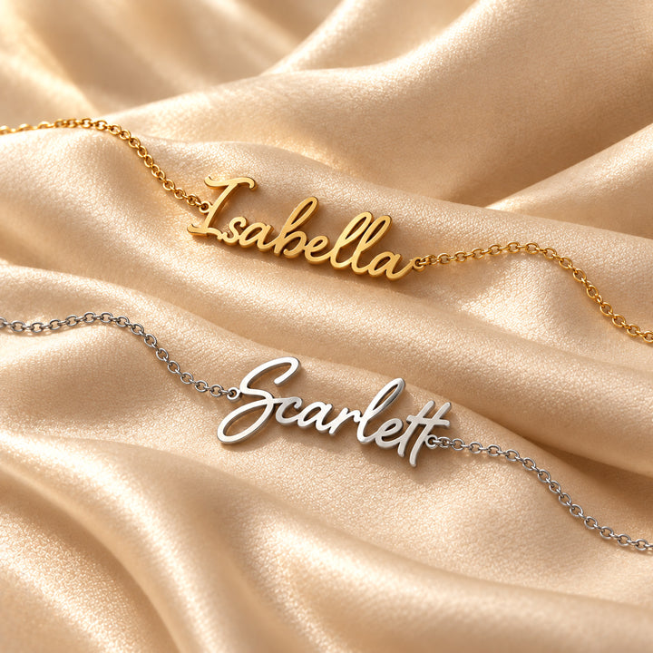 Gold and silver script name bracelets side by side, each with a name in flowing script