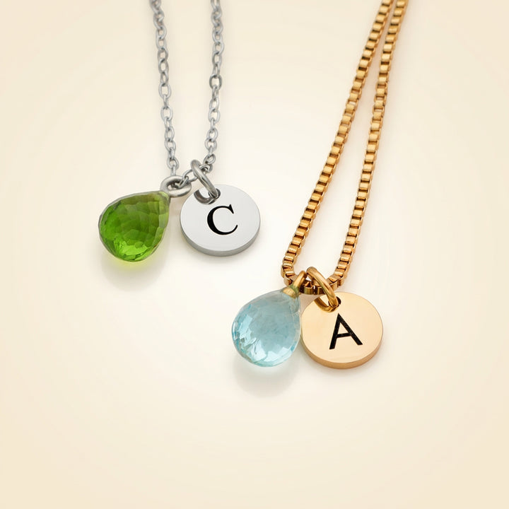 Faceted teardrop crystal birthstones styled flat lay