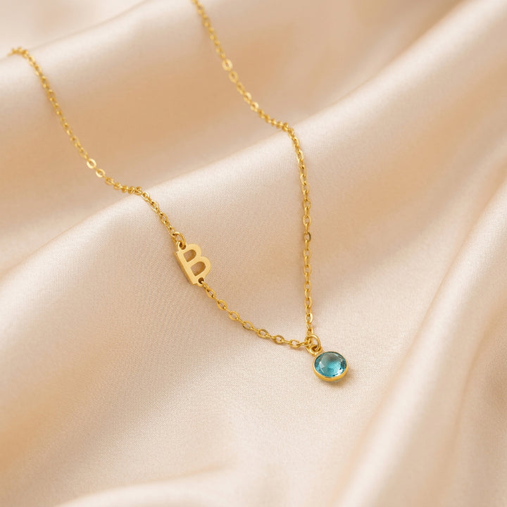 18K gold sideways initial necklace with crystal birthstone — personalised keepsake