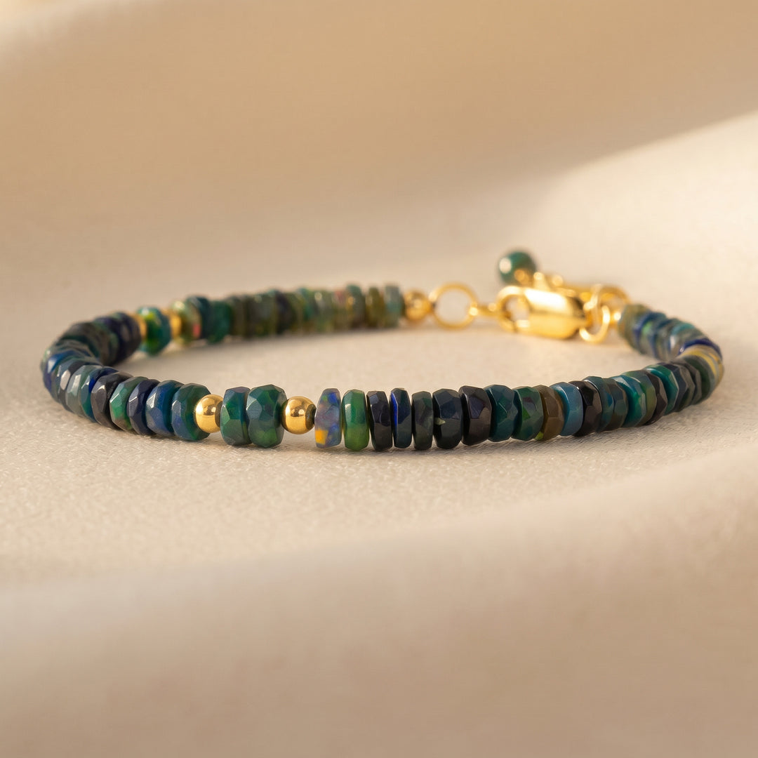 14K gold filled black opal bracelet on wrist — October birthstone, real Ethiopian opal