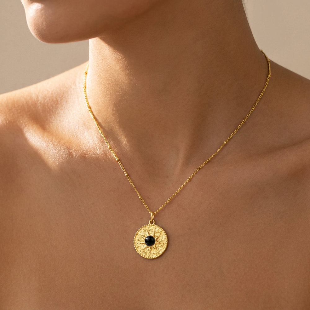 Gold black tourmaline sun necklace worn on chain — October birthstone gift