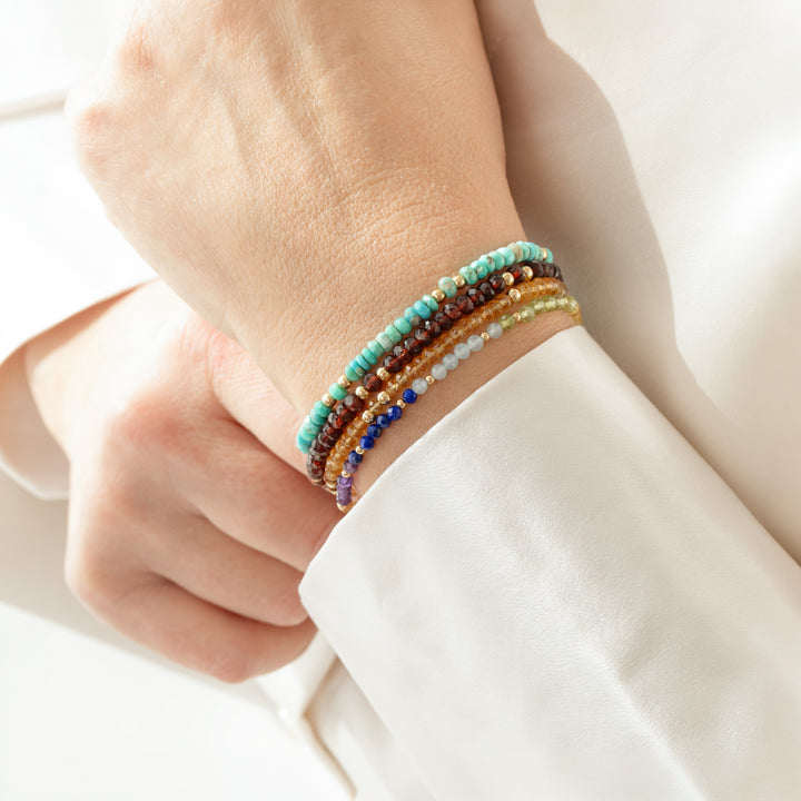 Garnet Fine bracelet on wrist  stacked with Abiza gemstone bracelets — real natural stones, hand-cut and faceted, statement strand