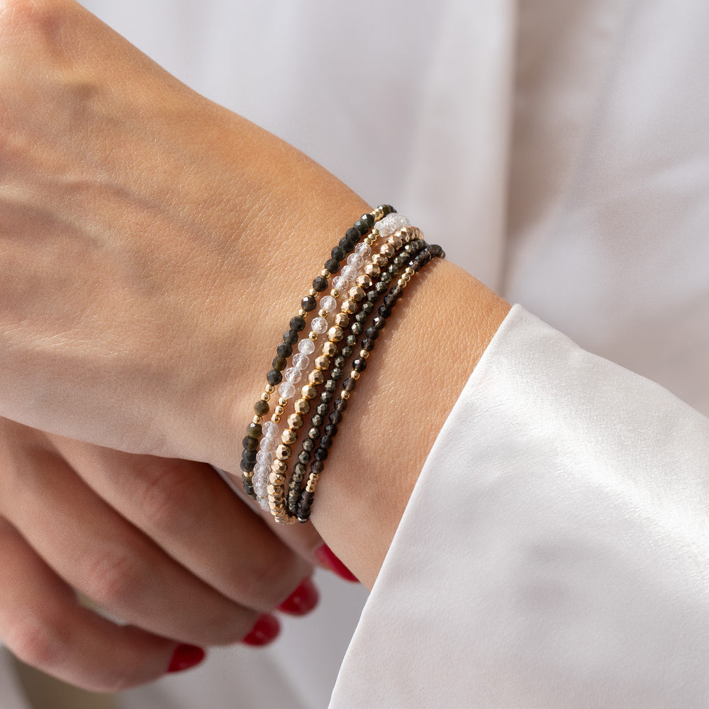 14K gold filled clear quartz bracelet stacked with other Abiza Skinny bracelets