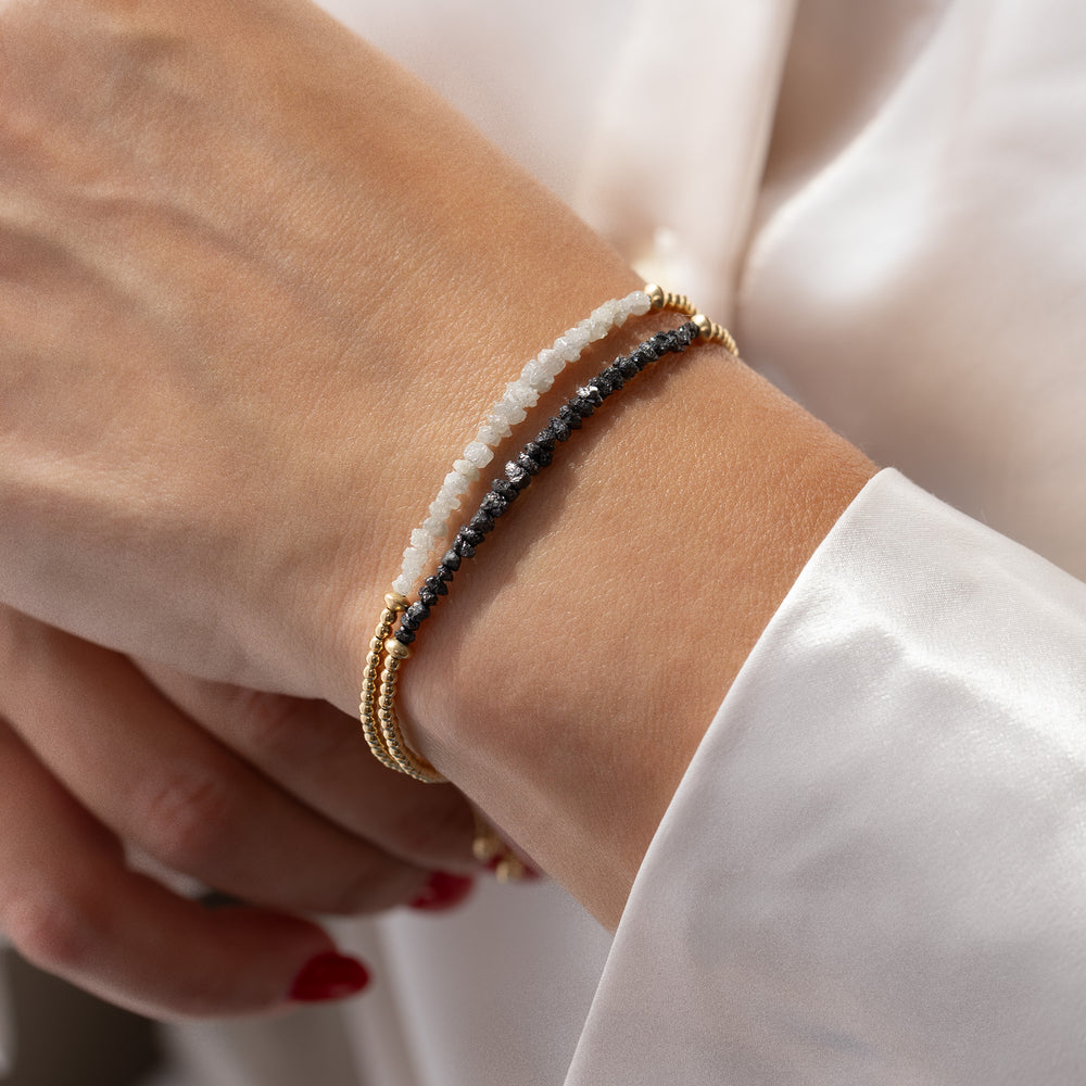 Raw black diamond bracelet stacked with raw grey diamond bracelet — two-tone wrist stack