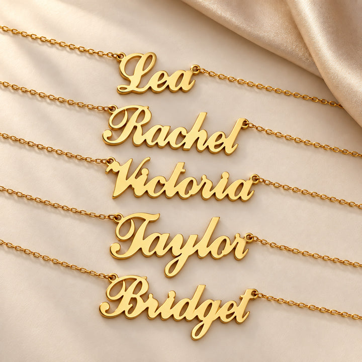 Five gold Carrie script name necklaces showing different names
