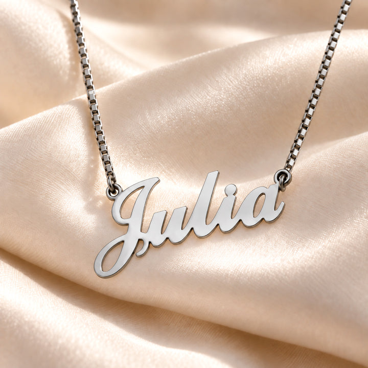 Silver Carrie name necklace on box chain with the name Julia