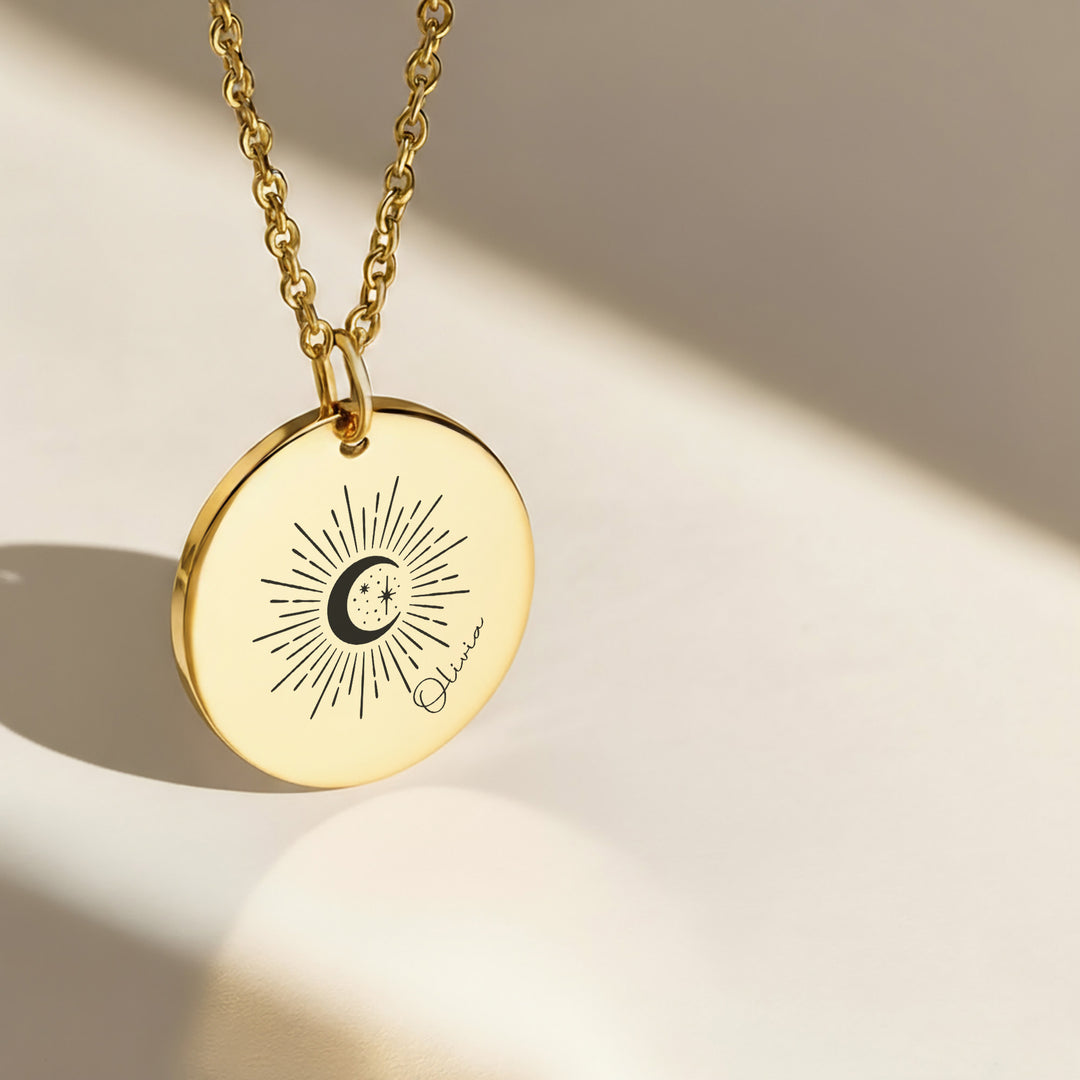 Gold celestial name necklace with engraved sunburst moon and stars