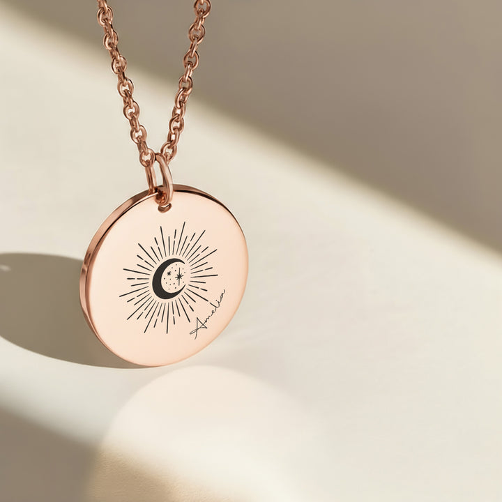 Rose gold celestial name necklace with engraved sun moon and stars pendant