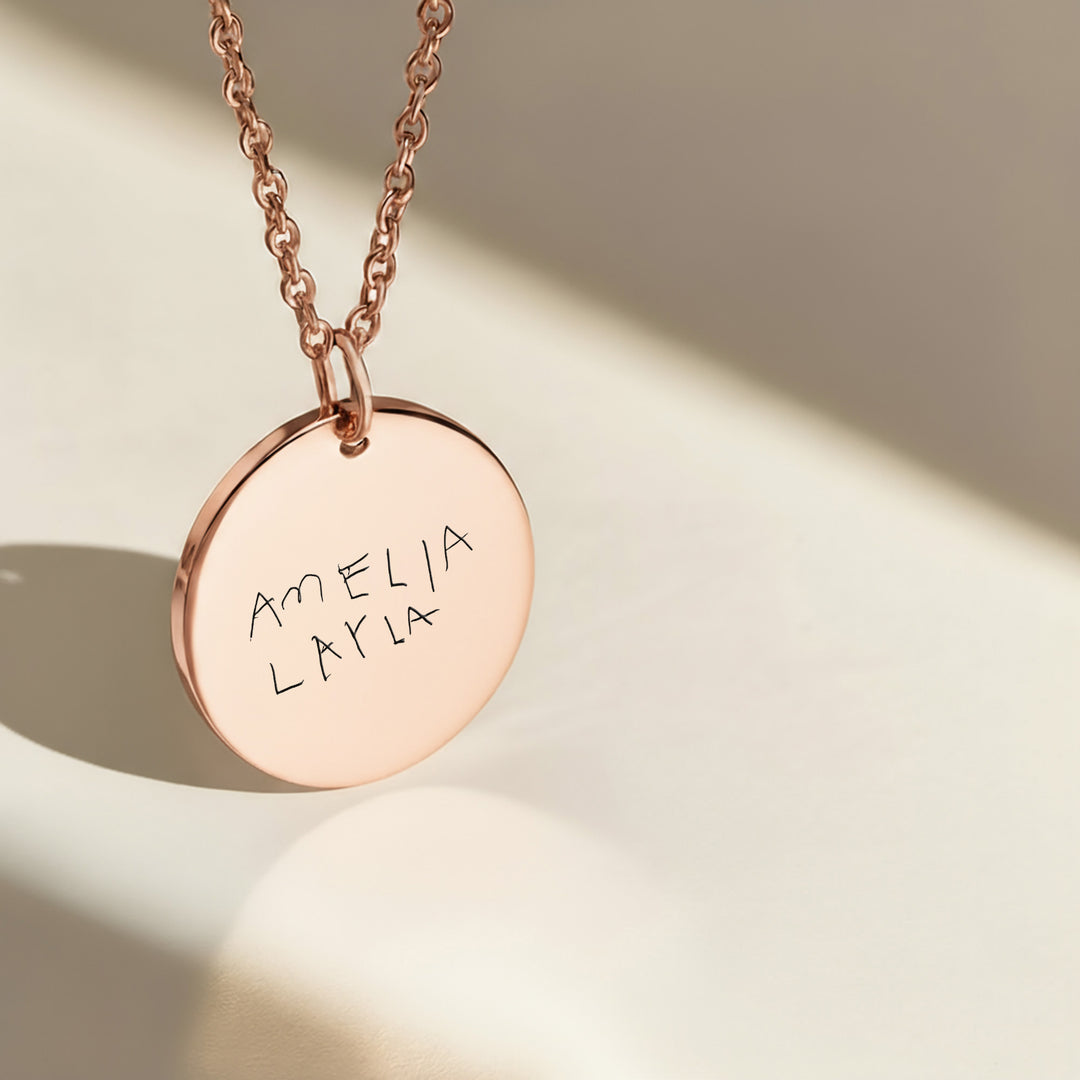 custom necklace engraved with childs handwriting on polished rose gold disc