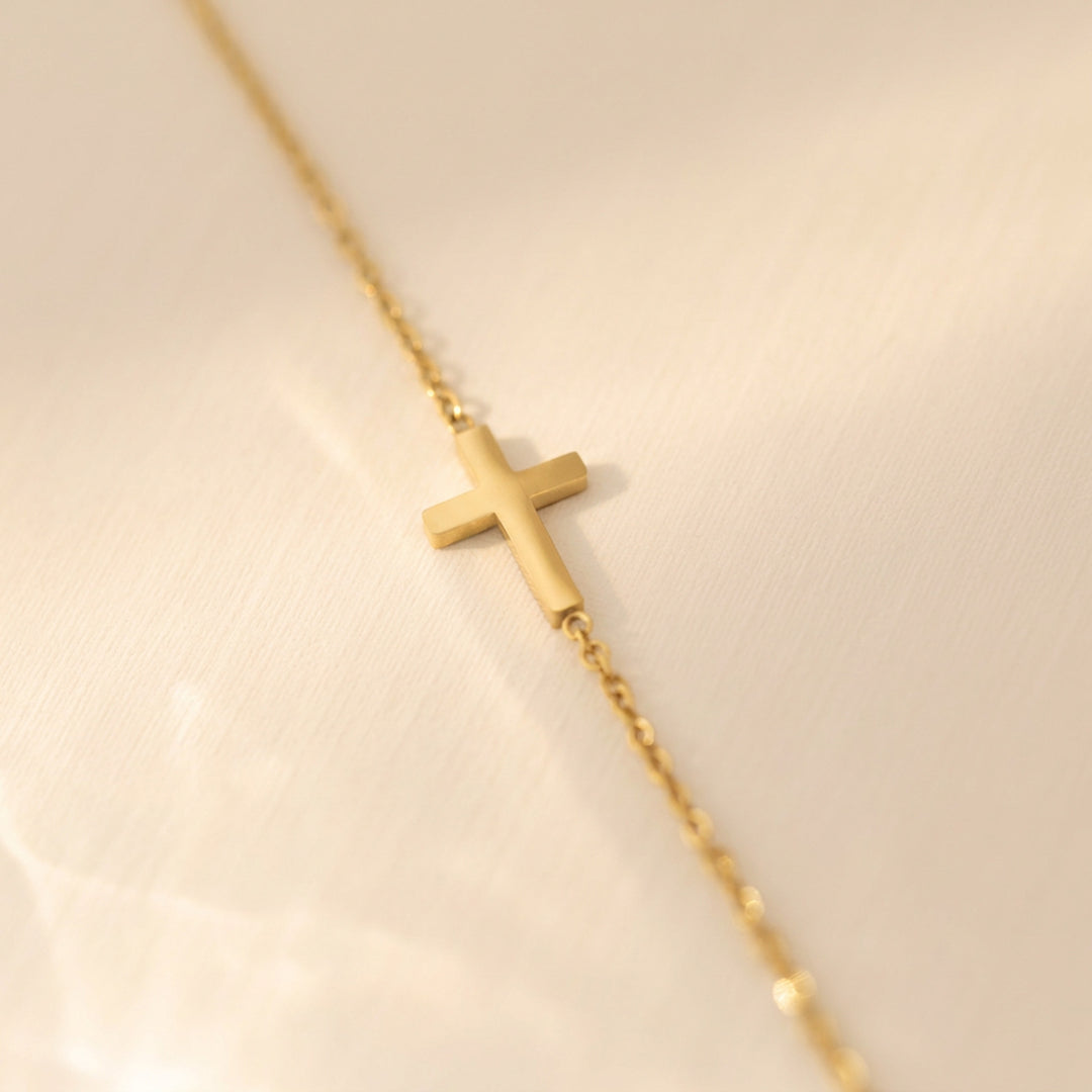18K gold plated sideways cross necklace on a fine cable chain