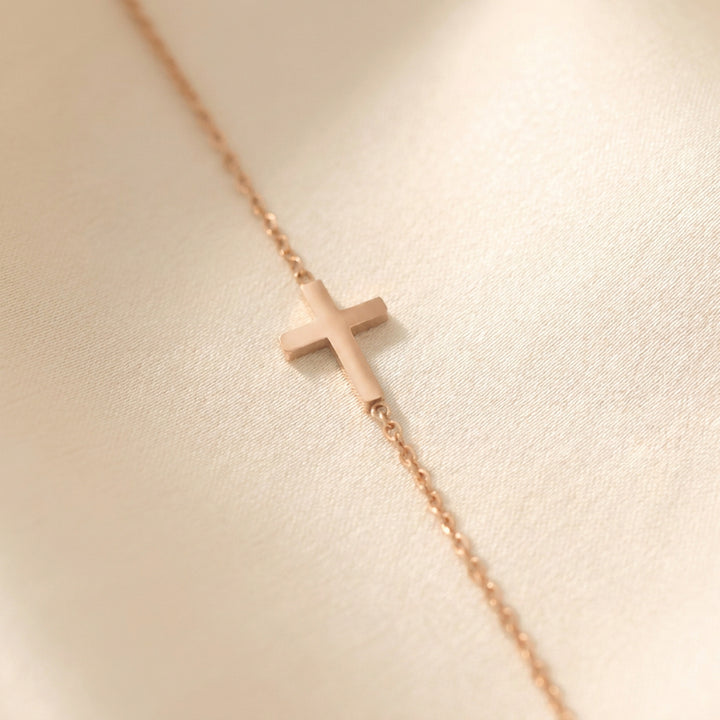 Rose gold sideways cross necklace on a fine cable chain