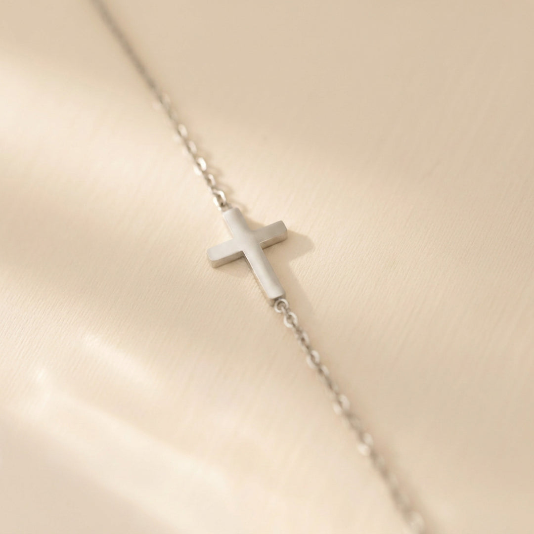 Silver sideways cross necklace on a fine cable chain
