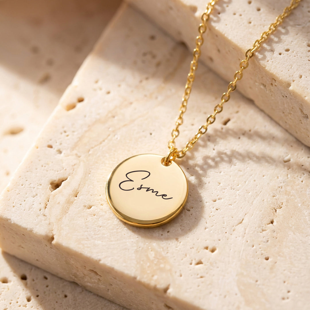 Personalised disc name necklace in gold engraved with Esme