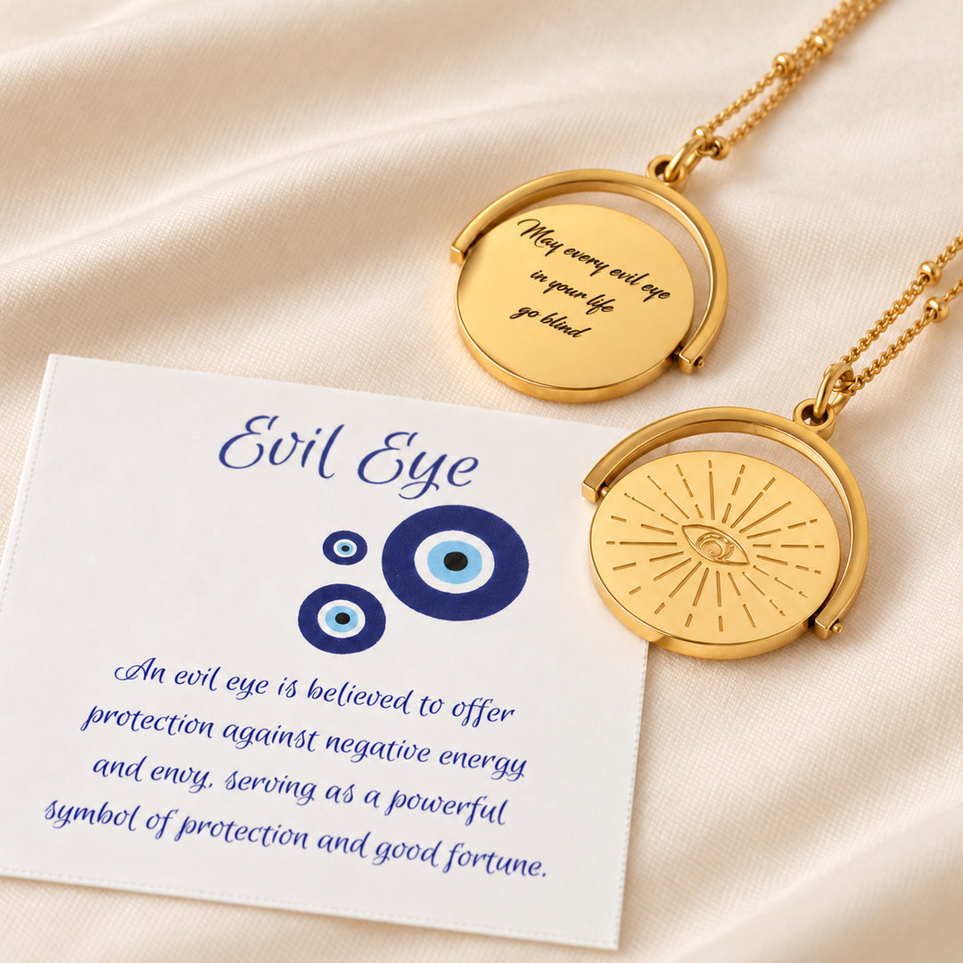 Evil eye spinner necklace showing both sides, with the evil eye meaning card it comes with