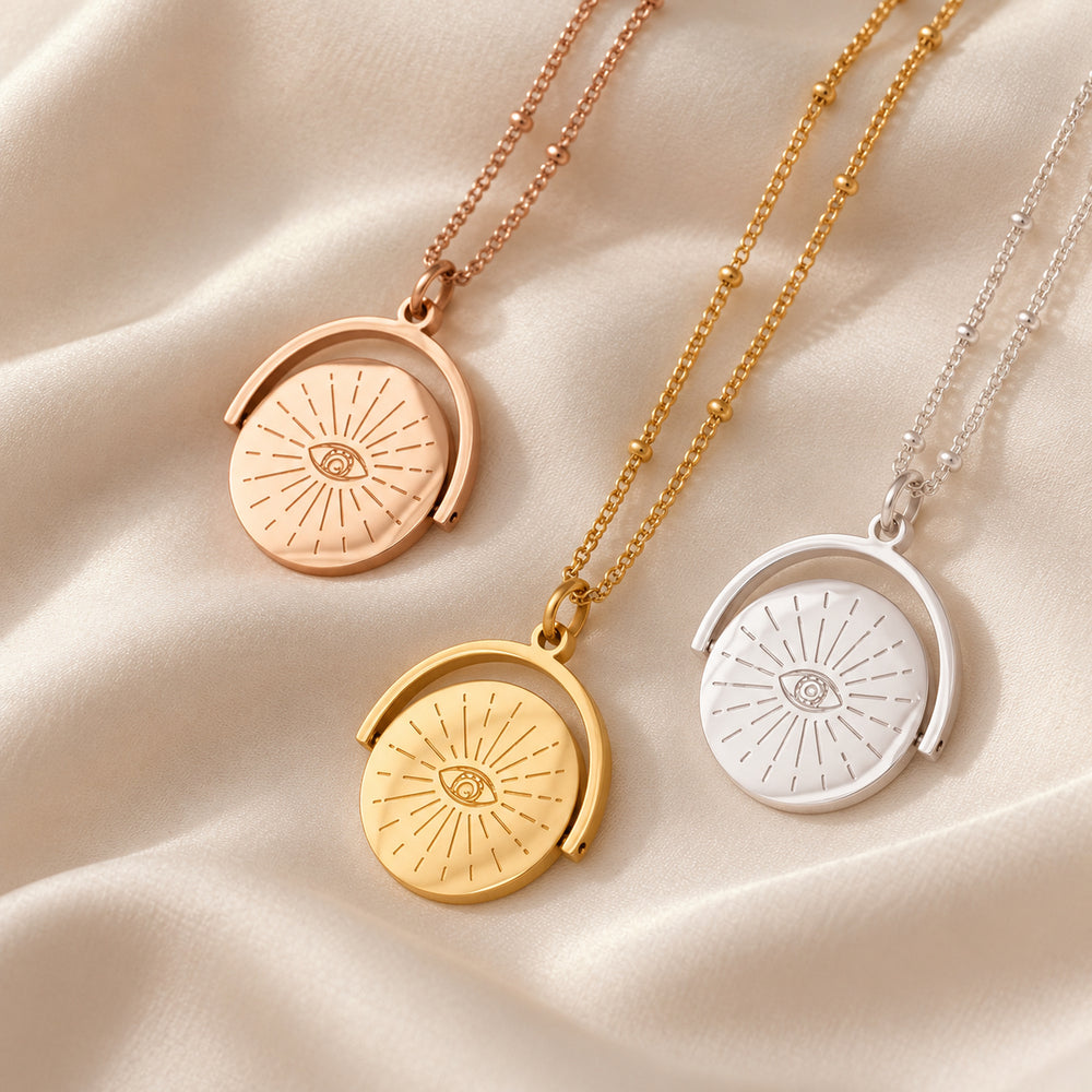 Evil eye spinner necklaces in gold, silver and rose gold on satin