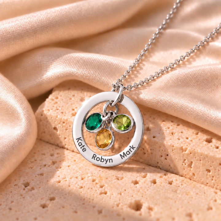 Silver family birthstone necklace engraved with three names and three birthstone charms