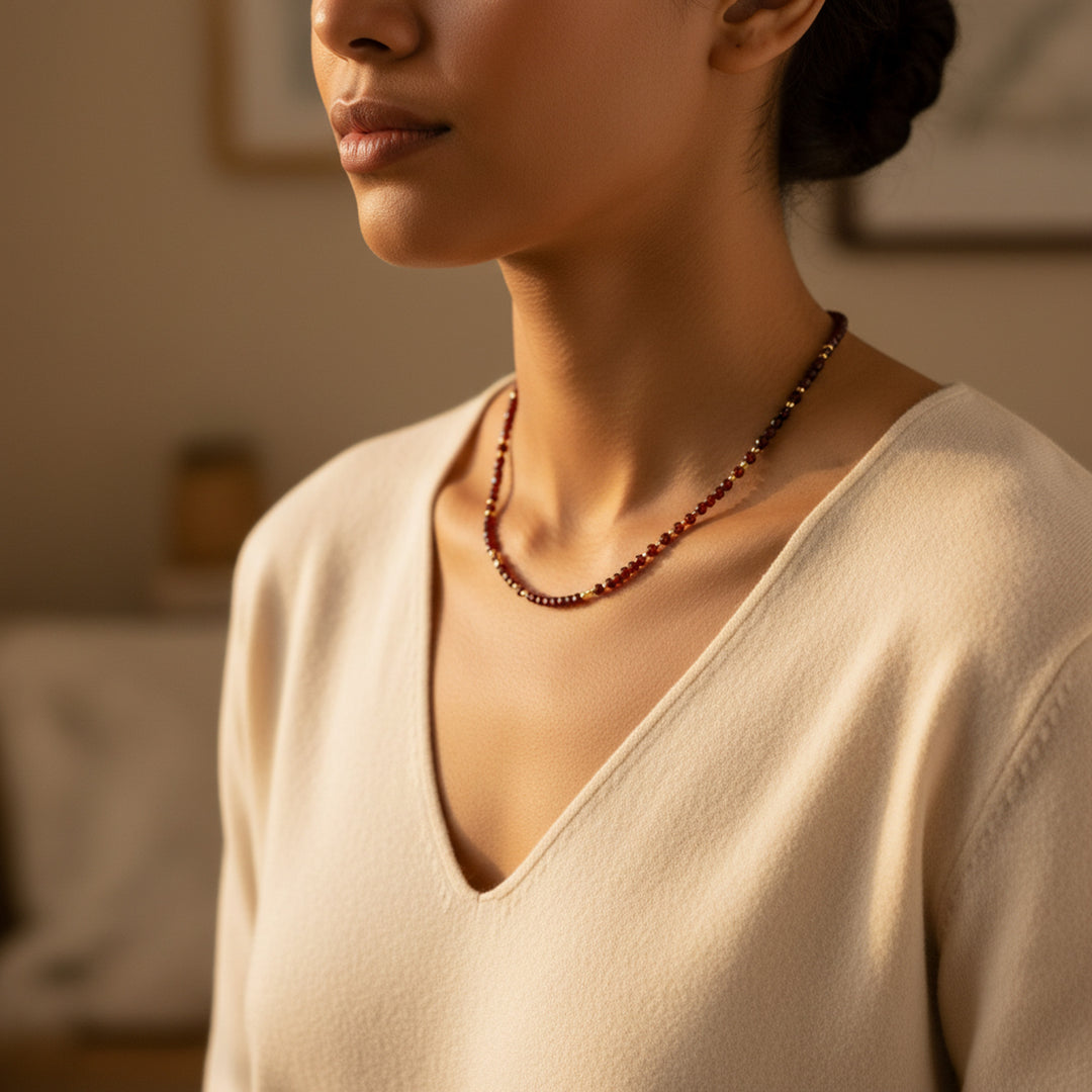 Model wearing matching garnet necklace — wear as a set with the bracelet