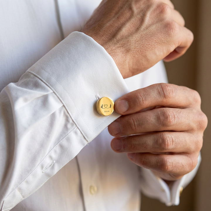 man wearing personalised gold wedding cufflinks with initials on white shirt