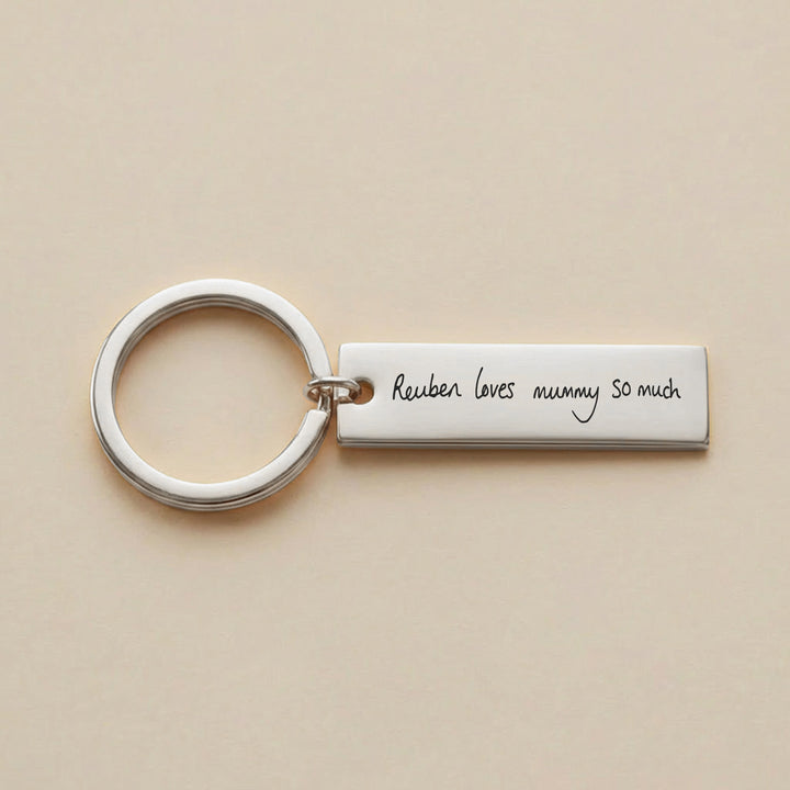Silver handwriting keyring engraved with Reuben loves mummy so much

