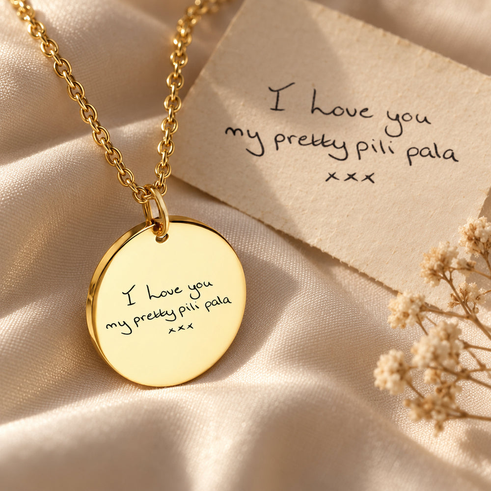 Handwritten note beside the gold necklace engraved with the same handwriting