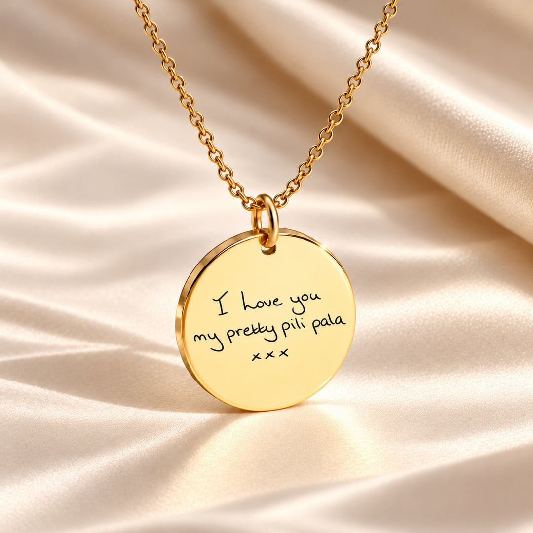 Gold handwriting necklace engraved with a handwritten love note and kisses