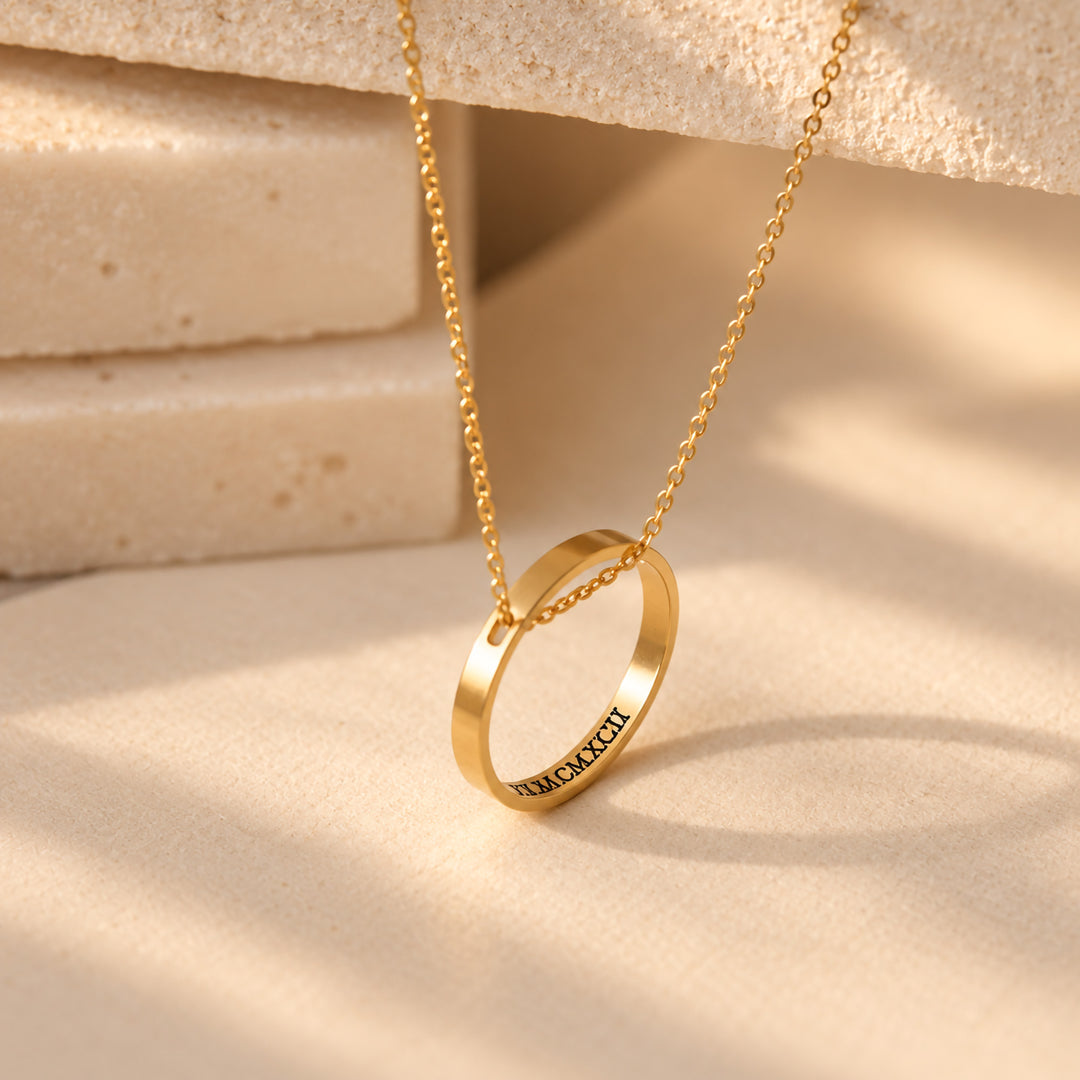 Gold circle necklace with a hidden message engraved inside