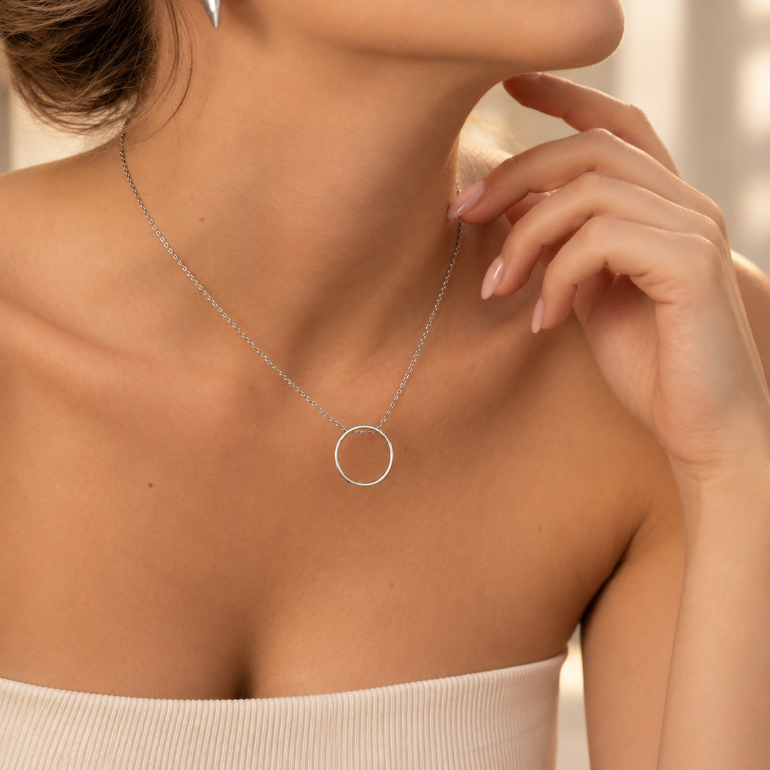 Silver open circle hidden message necklace worn on model