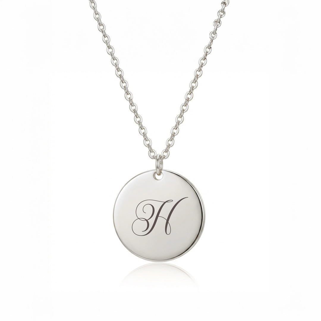 Silver initial disc necklace with engraved script letter H