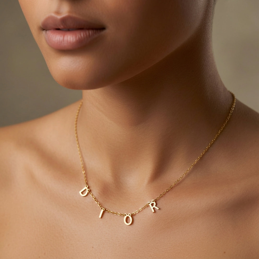 Personalised letter necklace styled at the collarbone — letter pendants and heart charm