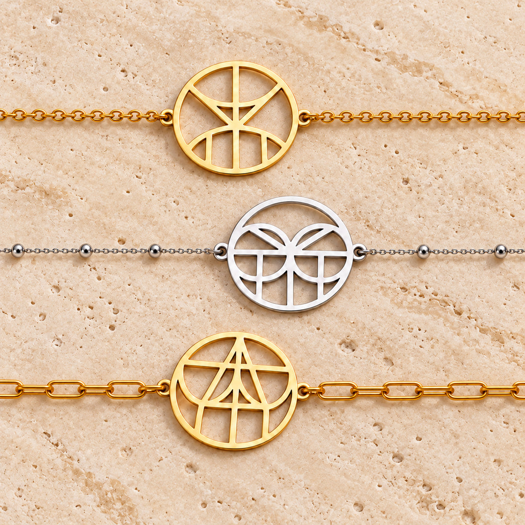 Three monogram name bracelets in gold and silver on cable, satellite and paperclip chains