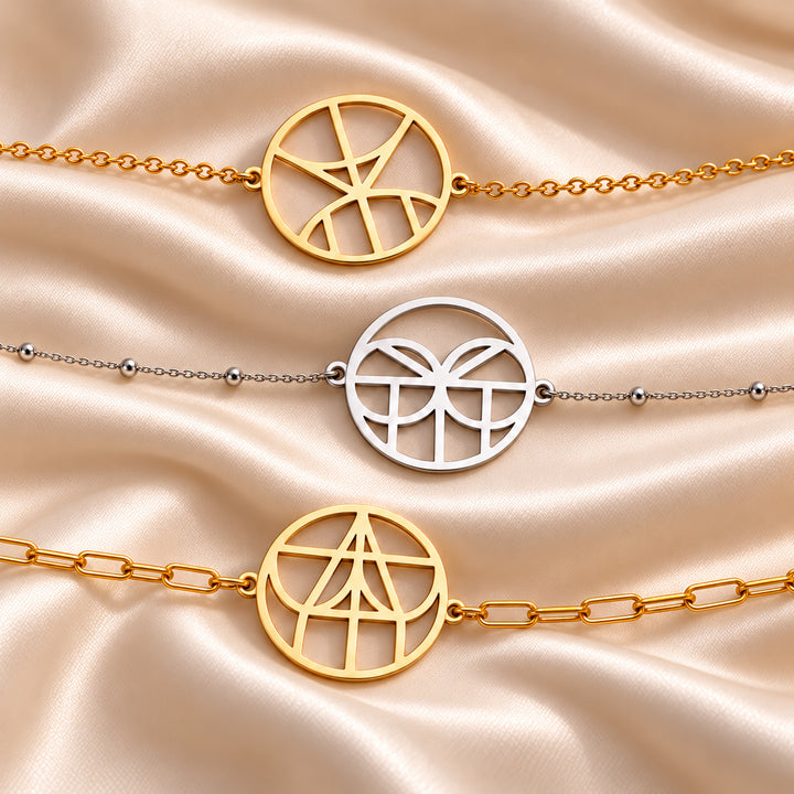 Monogram name bracelets in gold and silver shown on three chain styles