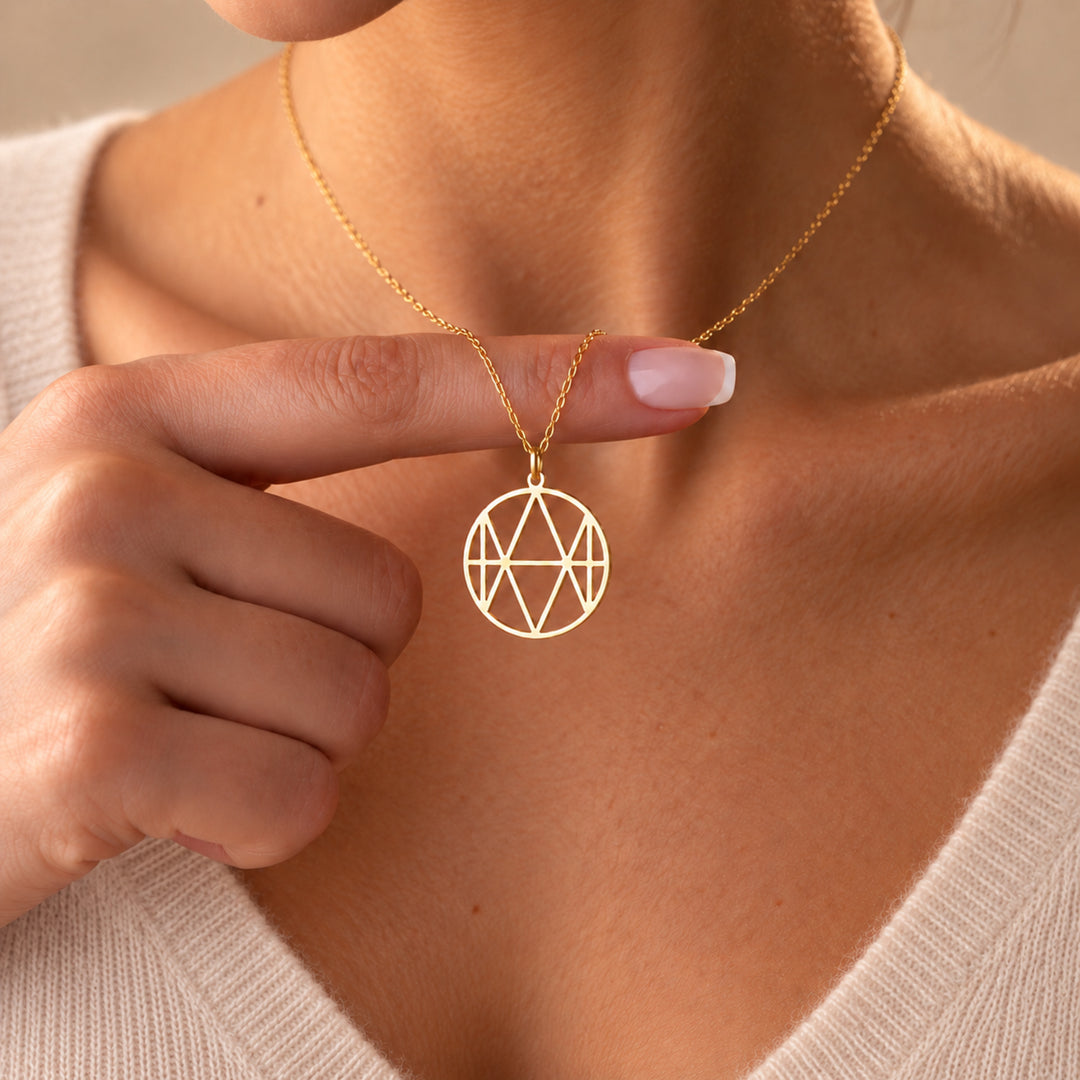 Gold monogram name necklace with the name Emma, worn on a fine chain