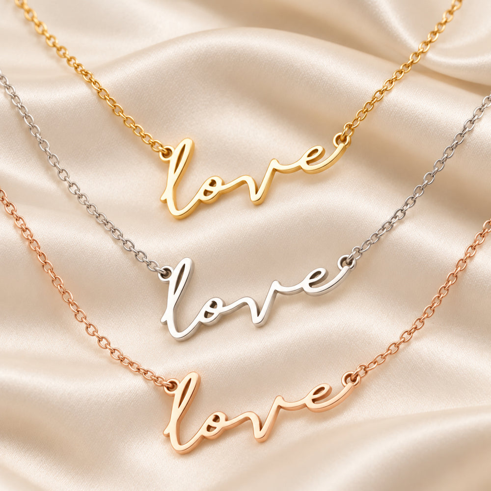 Love script necklaces in gold, silver and rose gold on satin