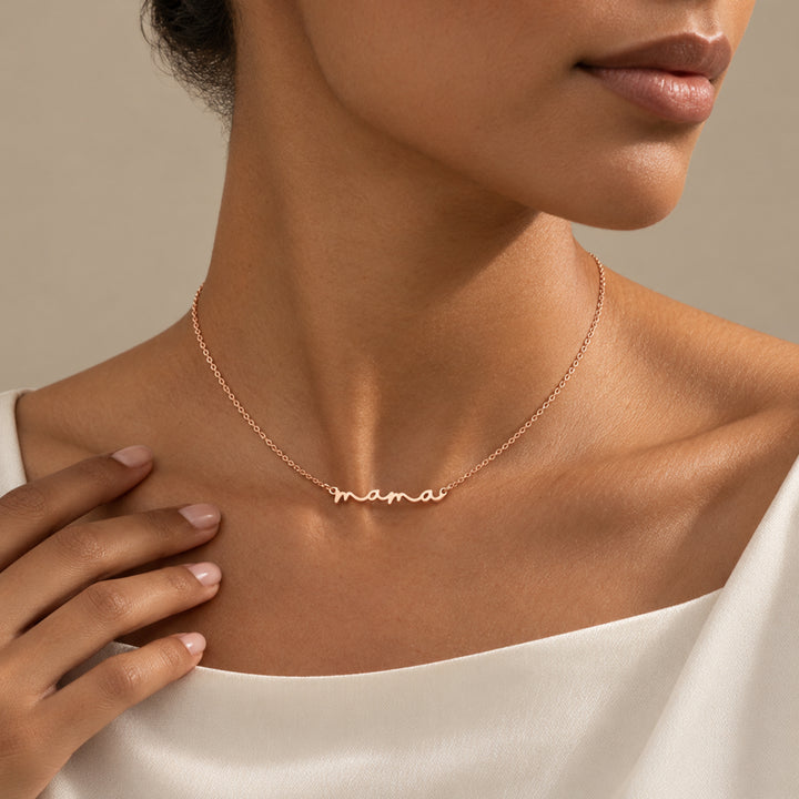 Model wearing a rose gold mama necklace with the word mama in script